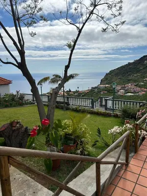 a view from the balcony of a house with plants at Tropical Garden in Arco da Calheta