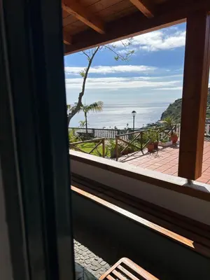 a window view of the ocean from a beach house at Tropical Garden in Arco da Calheta