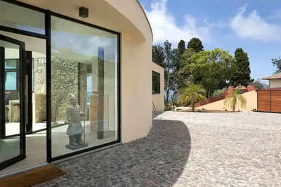 a building with large windows with a statue of a person at Villa Ohana in Estreito da Calheta