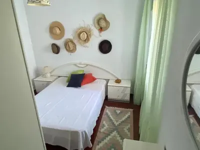 a bedroom with a bed and hats on the wall at Villa Mourisca in Aljezur