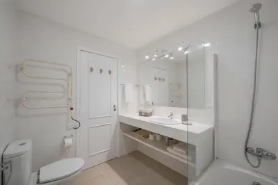 a white bathroom with a toilet and a sink at Casa da Cebola by An Island Apart in Santa Cruz