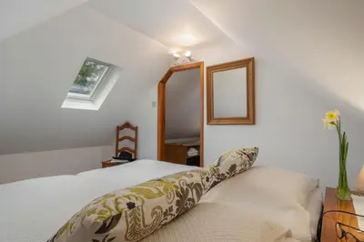 a bedroom with a bed with a pillow on it at Casa da Cebola by An Island Apart in Santa Cruz