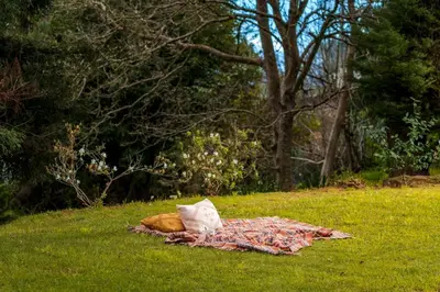 a blanket laying on the grass in a field at Casa da Cebola by An Island Apart in Santa Cruz