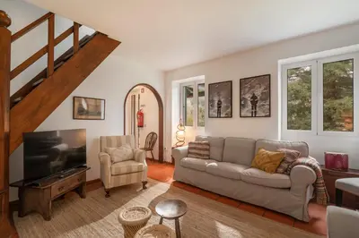 a living room with a couch and a tv at Casa da Cebola by An Island Apart in Santa Cruz