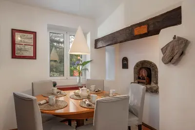 a dining room with a table and chairs and a fireplace at Casa da Cebola by An Island Apart in Santa Cruz