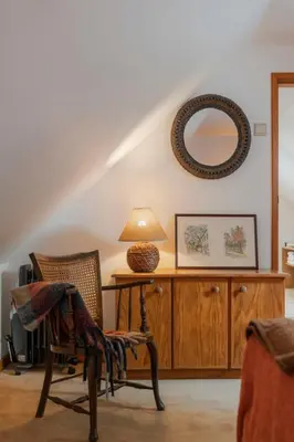a living room with a chair and a mirror at Casa da Cebola by An Island Apart in Santa Cruz