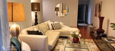 a living room with a couch and a table at Suite Palms in Funchal