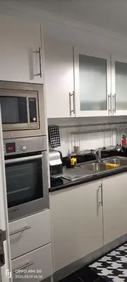 a kitchen with a sink and a stove top oven at Suite Palms in Funchal