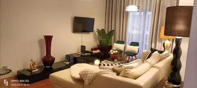 a living room with a white couch and a tv at Suite Palms in Funchal