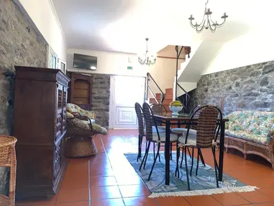 a dining room with a table and chairs at Terra Batista house in Porto da Cruz