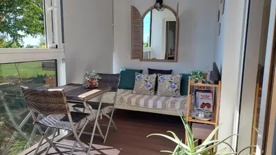 a porch with a couch and a table and a mirror at Viewpoint Machico - Lovely Nature View in Machico