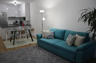 a living room with a blue couch and a table at Viewpoint Machico - Lovely Nature View in Machico