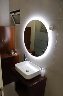 a bathroom with a white sink and a mirror at Viewpoint Machico - Lovely Nature View in Machico