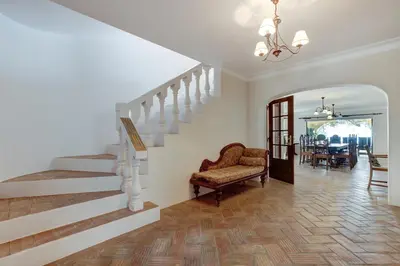 a living room with a staircase and a chair at Casa Sapo Gordo in Luz