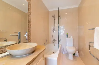 a bathroom with a sink and a tub and a toilet at Casa Sapo Gordo in Luz