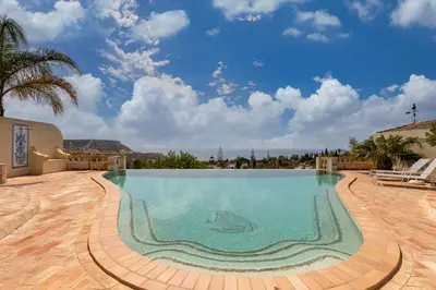 a swimming pool in a resort with a shark in the water at Casa Sapo Gordo in Luz