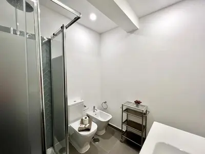 a bathroom with a toilet and a glass shower at Lagos Ocean Breeze 1 by Homing in Lagos