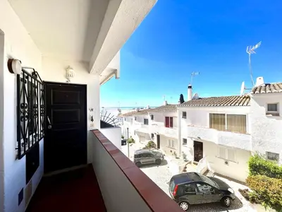 a balcony with a door and a car on a street at Lagos Ocean Breeze 1 by Homing in Lagos