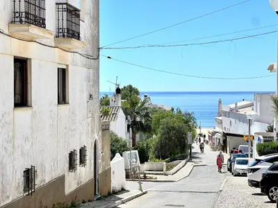 a street in a town with the ocean in the background at Lagos Ocean Breeze 1 by Homing in Lagos