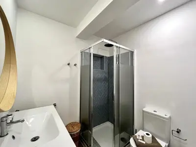 a white bathroom with a shower and a sink at Lagos Ocean Breeze 1 by Homing in Lagos