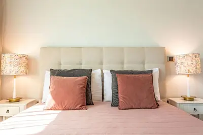 a bedroom with a large bed with two lamps at Leonor Seaview Apartment in Funchal