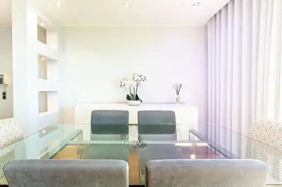 a dining room with a glass table and two chairs at Leonor Seaview Apartment in Funchal
