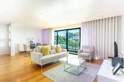 a living room with a couch and a table at Leonor Seaview Apartment in Funchal