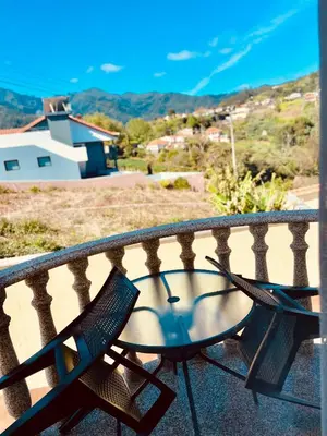 a table and chairs sitting on a balcony at Belle Vue in São Jorge