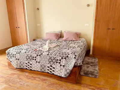 a bedroom with a bed with a stuffed animal on it at Belle Vue in São Jorge