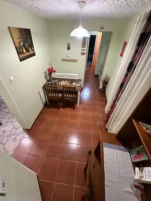 a hallway with a tile floor and a table at 2 bed room apartment , sea view, 10 minutes walk to the beach in Ribeira Brava