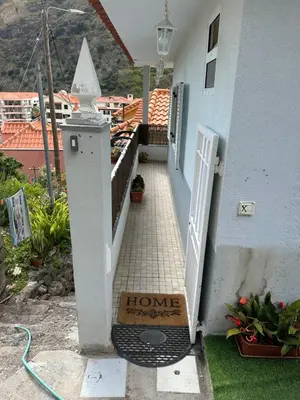 a house with a home improvement sign on a porch at 2 bed room apartment , sea view, 10 minutes walk to the beach in Ribeira Brava