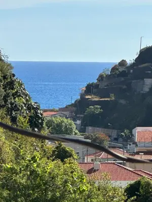 a view of the ocean from a hill at 2 bed room apartment , sea view, 10 minutes walk to the beach in Ribeira Brava