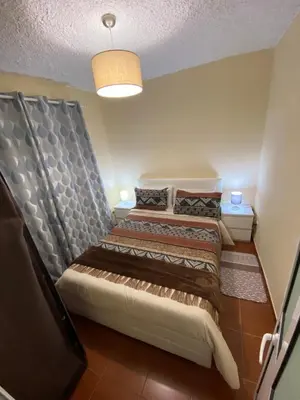 a bedroom with a bed with a headboard at 2 bed room apartment , sea view, 10 minutes walk to the beach in Ribeira Brava