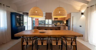 a kitchen with a wooden table and chairs at Az Ribat Sea e Sun in Aljezur