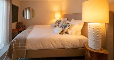 a bedroom with a bed with a lamp on it at Az Ribat Sea e Sun in Aljezur