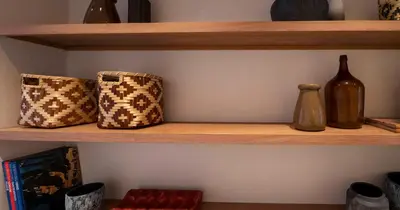 a wooden shelf with bottles and bags on it at Az Ribat Sea e Sun in Aljezur