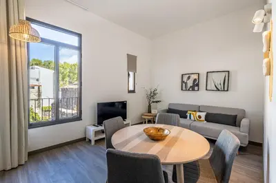 a living room with a table and a couch at Fort Bay Suite Apartments in Machico