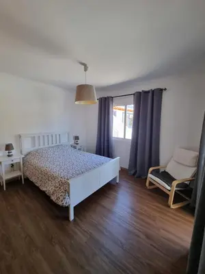 a white bedroom with a bed and a window at Casa agapanthe in Estreito da Calheta