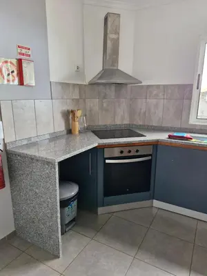a kitchen with a sink and a stove top oven at Casa agapanthe in Estreito da Calheta