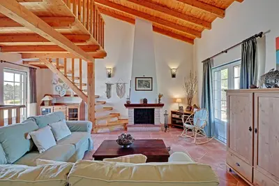 a living room with a couch and a fireplace at Casa Lady D'Avila in Aljezur