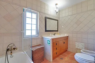 a bathroom with a sink and a toilet and a tub at Casa Lady D'Avila in Aljezur
