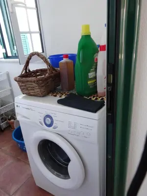 a washing machine with a basket on top of it at Casa Lady D'Avila in Aljezur