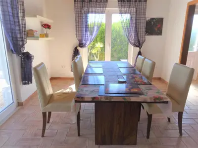 a dining room table with chairs and a long table at Casa Brisa Suave in Aljezur