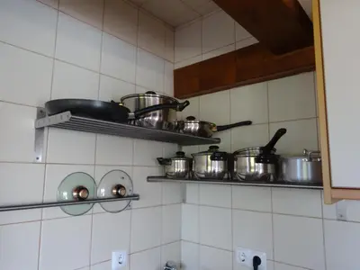 a kitchen with pots and pans on shelves at Casa Brisa Suave in Aljezur
