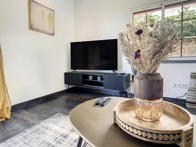 a living room with a table and a tv at Casa DaSa by LovelyStay in Salão