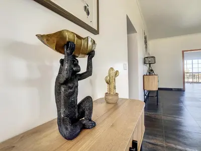 a statue of a person holding a pot on a table at Casa DaSa by LovelyStay in Salão