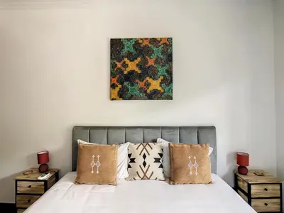 a bedroom with a bed with pillows and a painting on the wall at Casa DaSa by LovelyStay in Salão